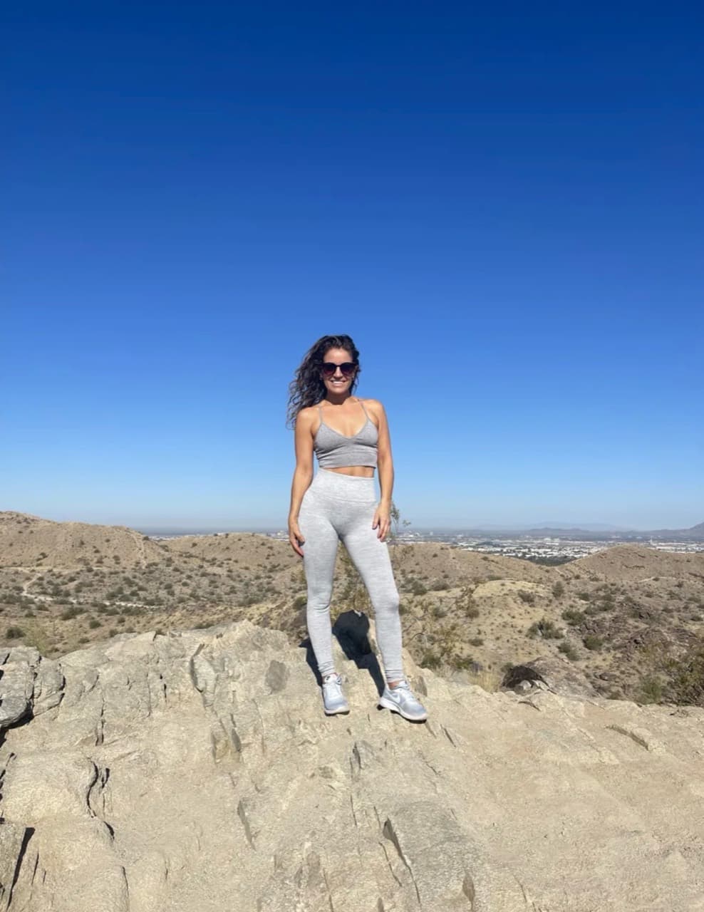 Woman standing on a desert trail during a hike