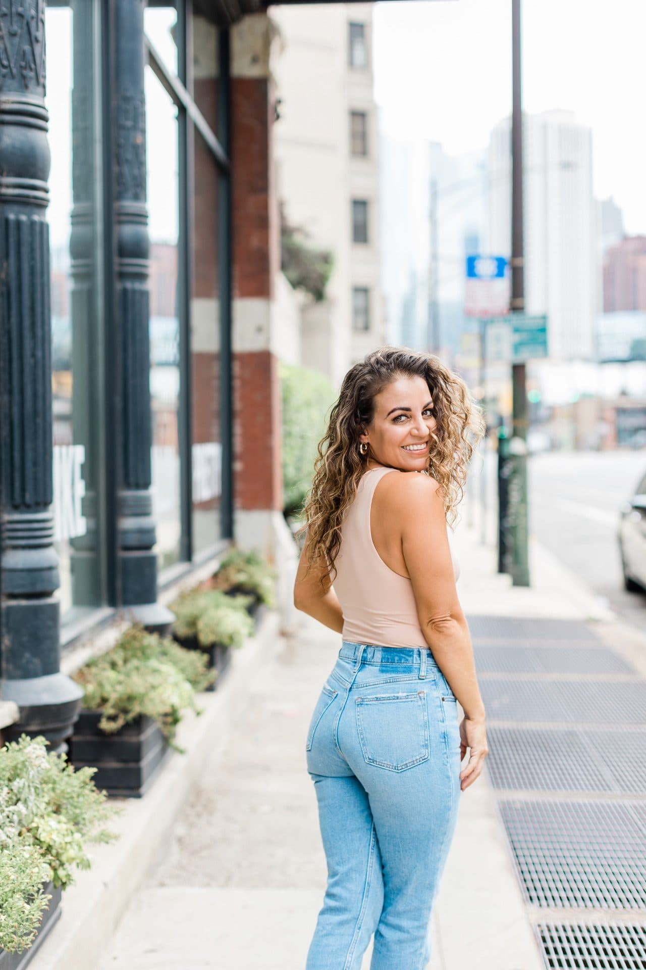 Jenn Dieas on a Chicago sidewalk, looking back at the camera