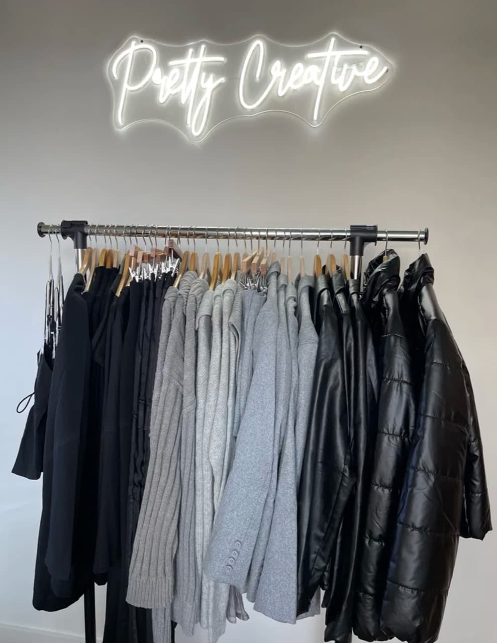 Pretty Creative merchandise displayed beneath a glowing Pretty Creative sign